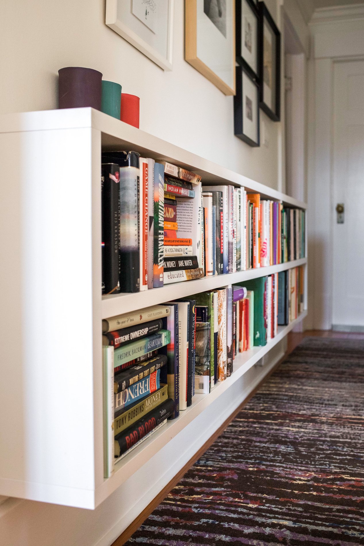 Floating bookshelves Floating low height bookshelves in hallway