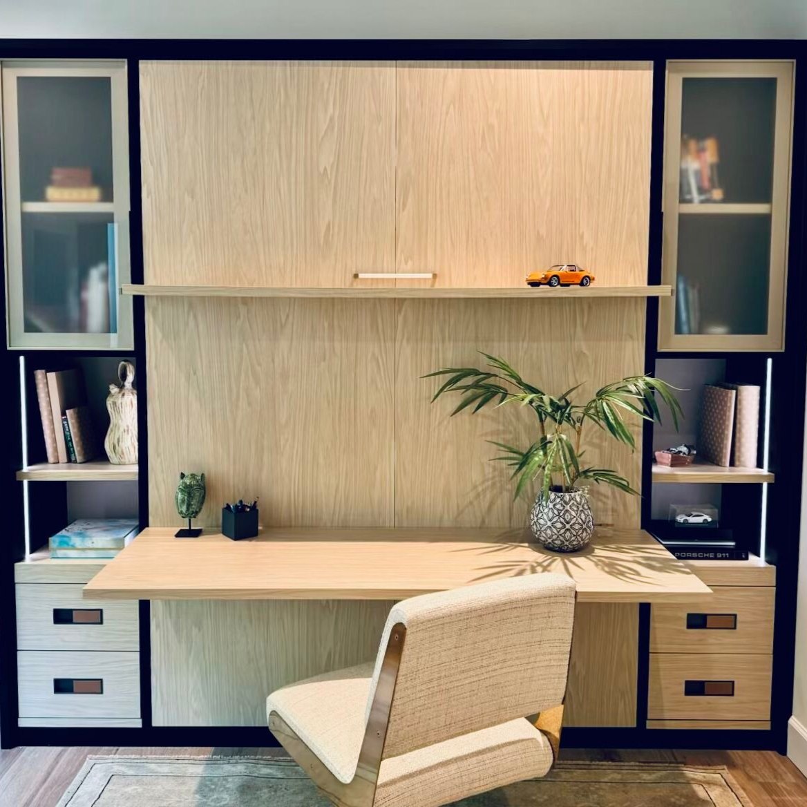 Custom Home Office Custom built-in home office with wood-grain cabinetry, glass-front display cabinets, open shelving, drawers, and spacious desk.