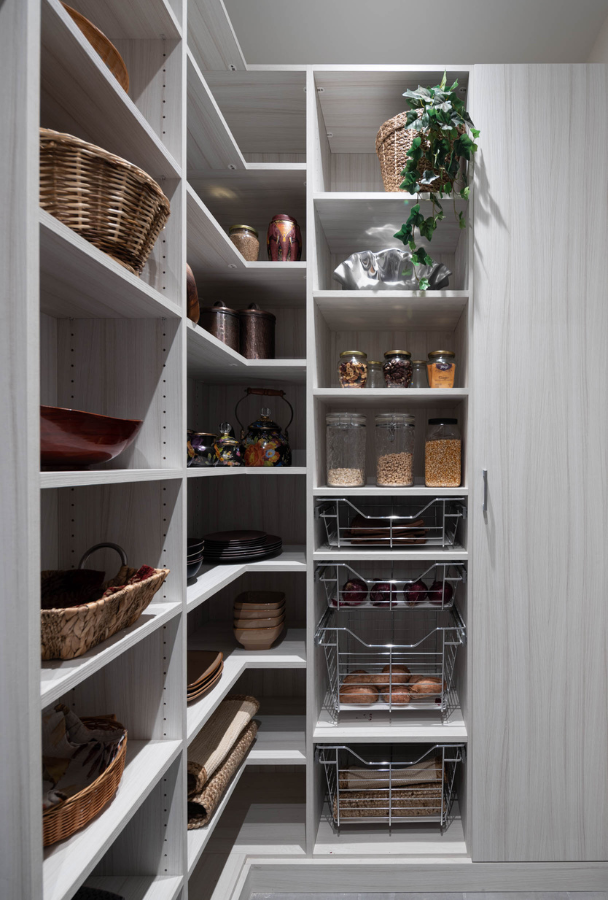 Chic Pantry White Wood custom pantry with one closed cabinetry for brooms, and different sizing shelving for various pantry items Westchester NY