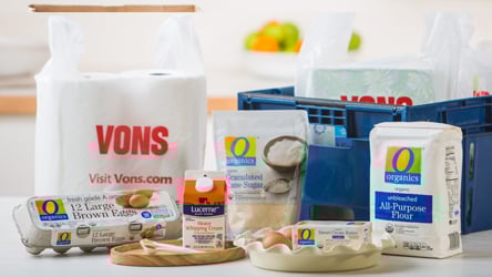 Vons Grocery bags, delivery box and groceries such as eggs, flour and cream.