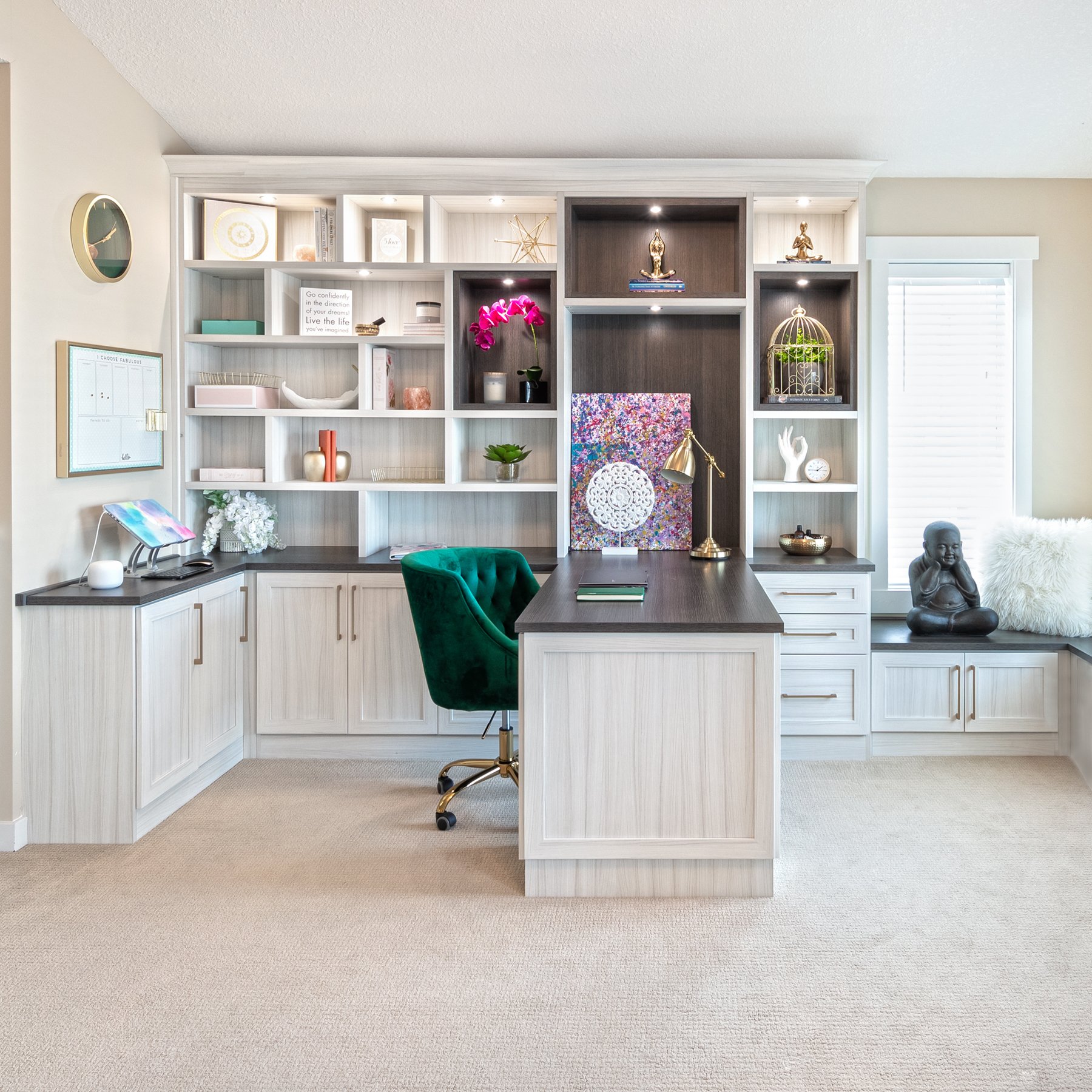 Home Office Retreat Home Office-Design of the Year 2020.
Home Office with a light wood grain finish and accented countertop, display boxes peninsula desk, closed cabinetry, open shelving, lighting, and a bench.