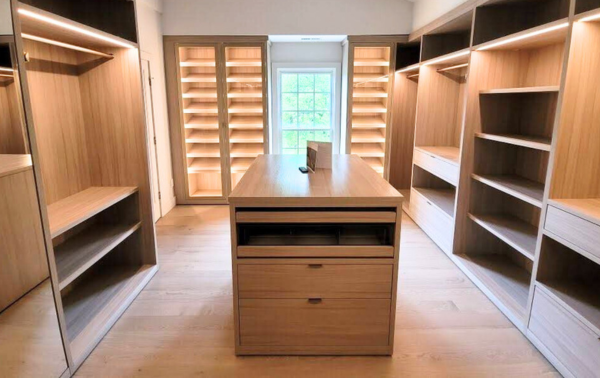 Luxury Walk-In Closet California Closets Westchester New York Large Walk-in Closet Natural Wood Color LED lighting Closed Cabinetry Hanging Angled Shoe Shelving