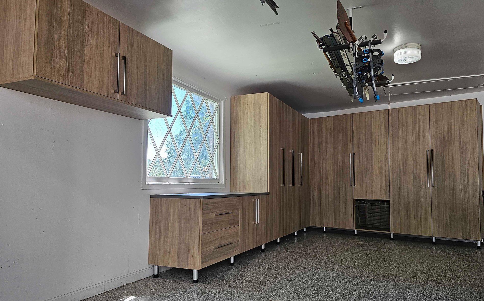 Custom Garage Garage storage with A counter top, tall cabinets, and high up cabinets