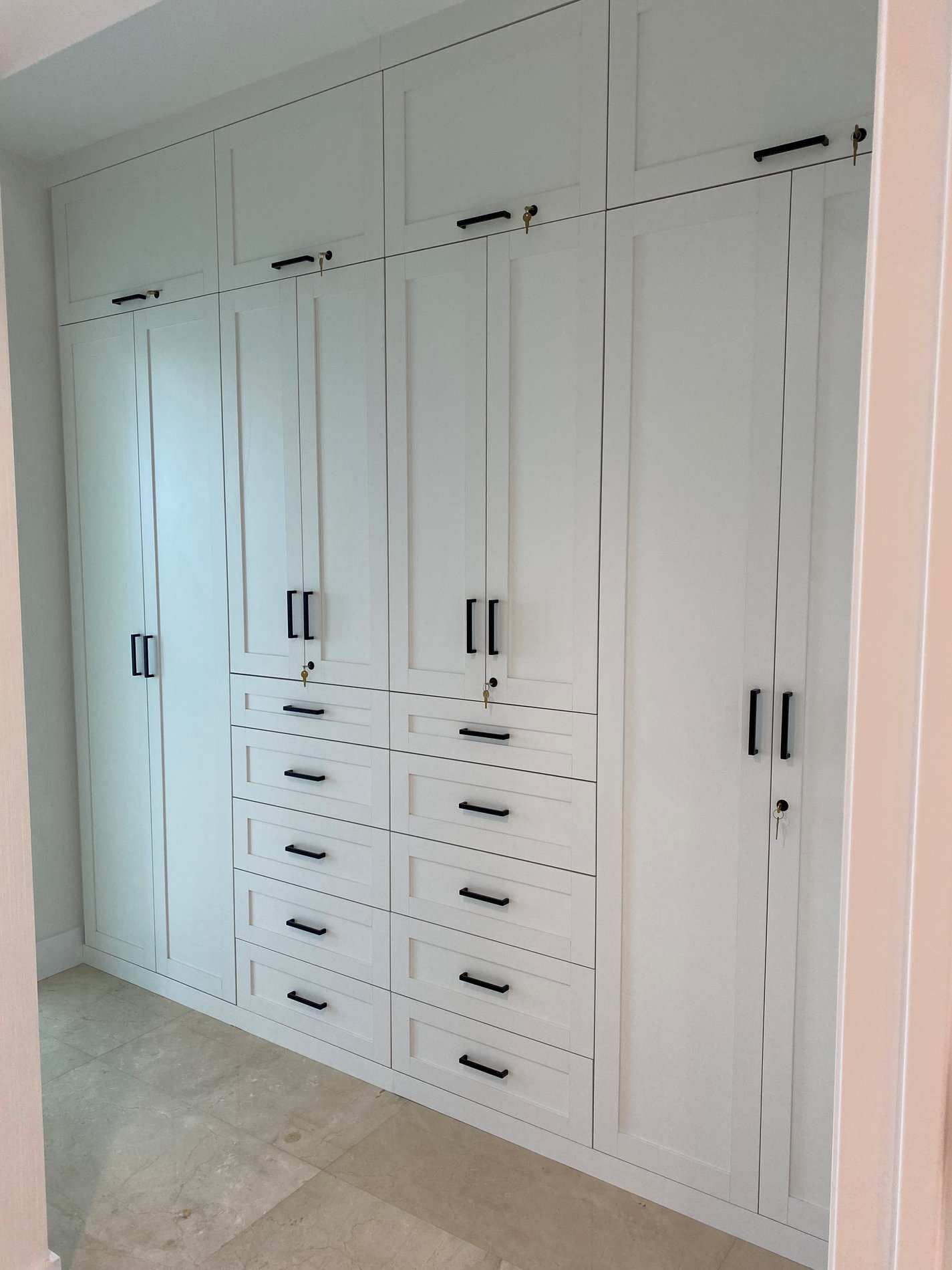 Unlimited room for storage White wardrobe closet with dark hardware