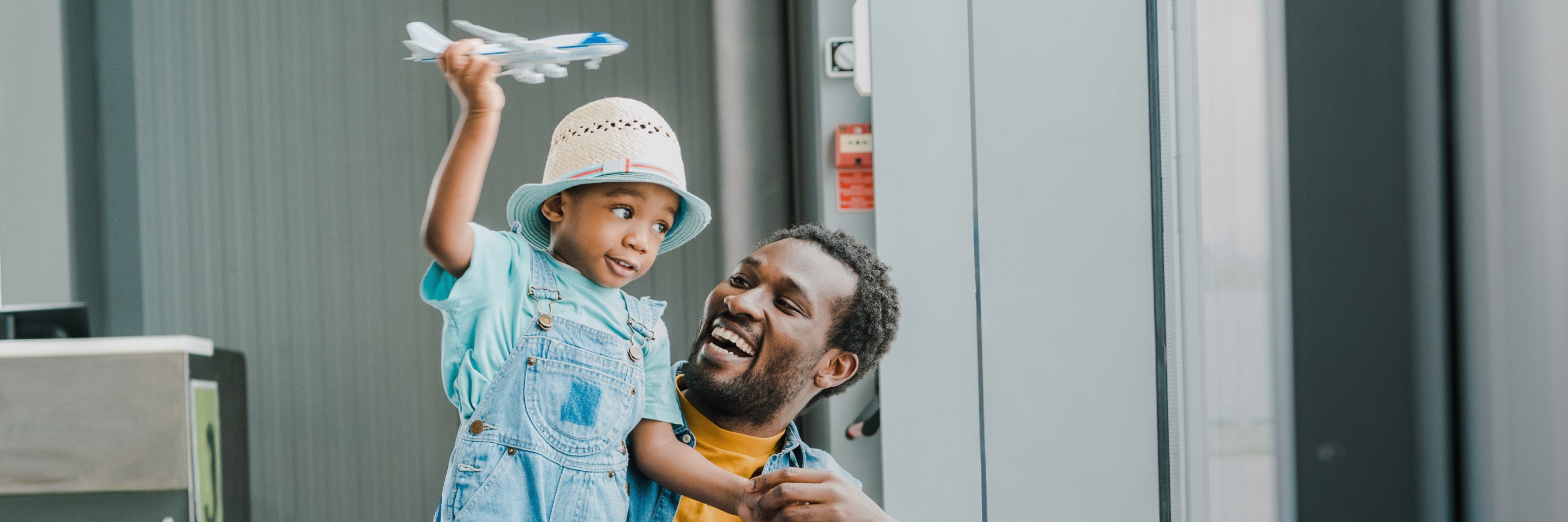 father and son playing with an airplane