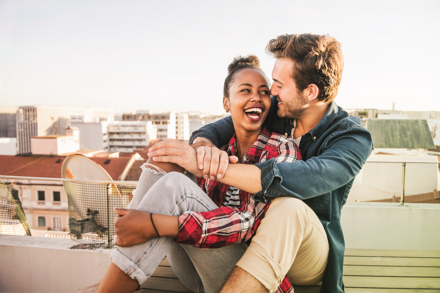 Couple enjoying each other's company on a rooftop.