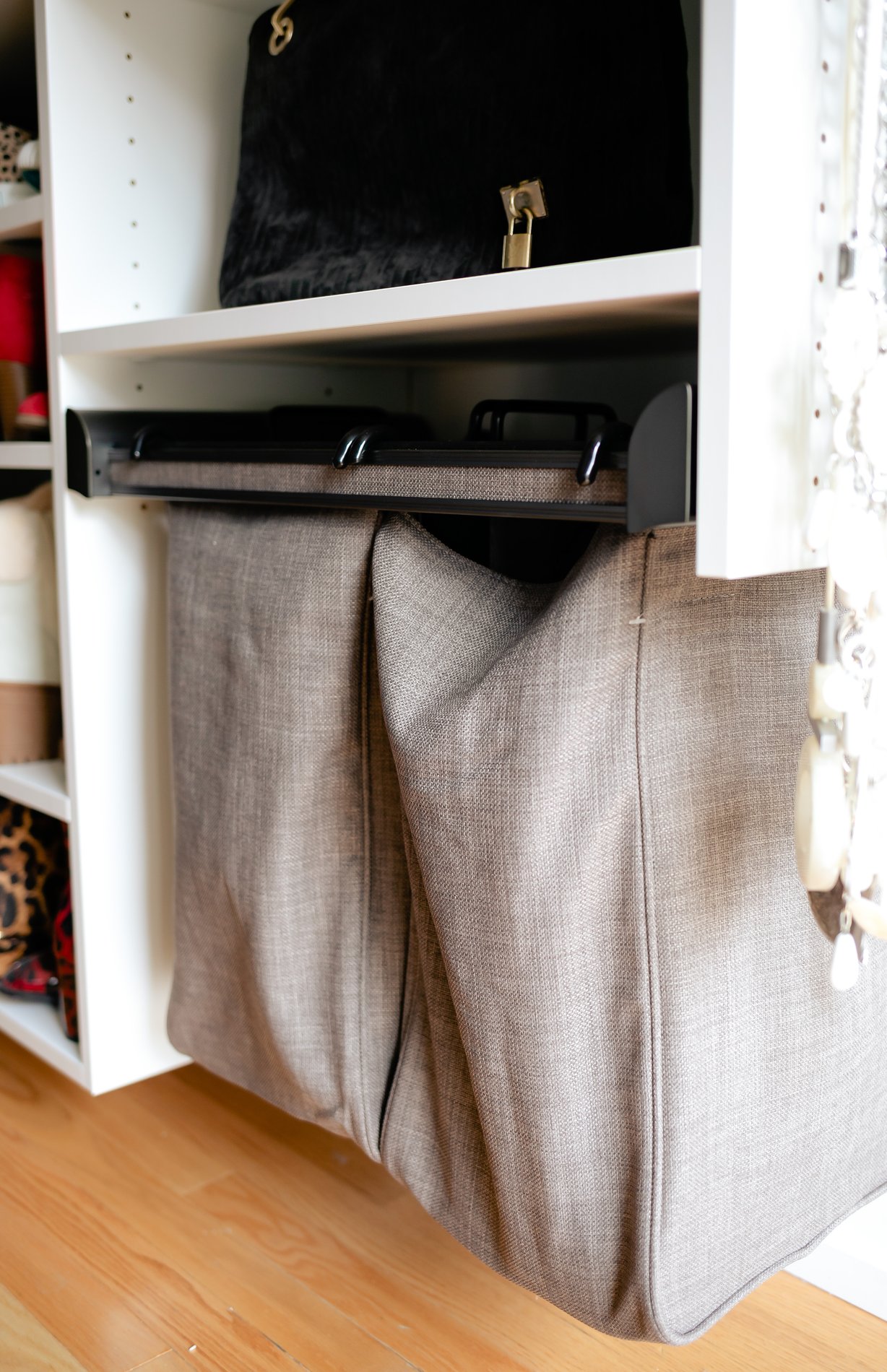 Walk-in closet with pull-out laundry bag Suspended closet section with pull out laundry bags