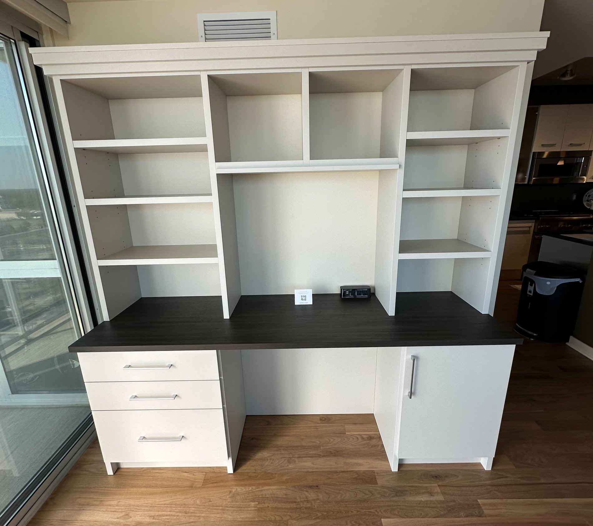 At Home Office White Built in desk with a dark brown countertop. With shelving and Drawers