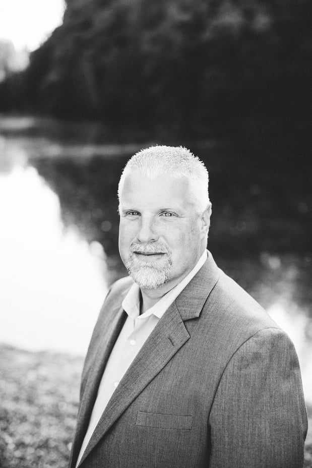 Male agency owner. Ryan Deskins gray background.