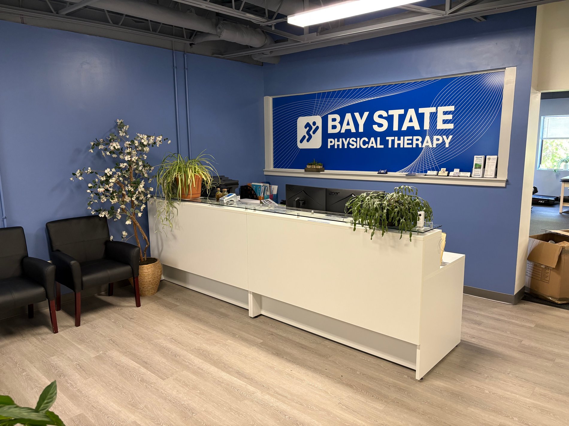 Bay State Physical Therapy - Bedford MA front desk and waiting room area.