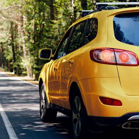 Yellow SUV on country road