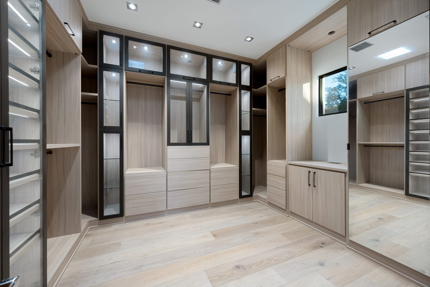 Luxe Master Walk In Closet with Lighting Custom walk in closet with glass doors and lighting