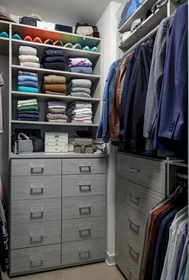 Color Coordinated Closet gray his side walk-in closet with shelving for folded clothing, drawers, and hanging for suit jackets Brooklyn New York
