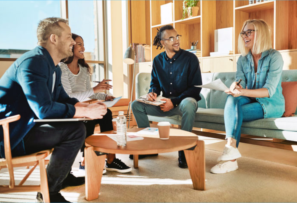 People in an office setting sitting down having a conversation