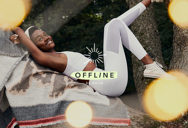 woman lounging in tree in leggings and sports bra