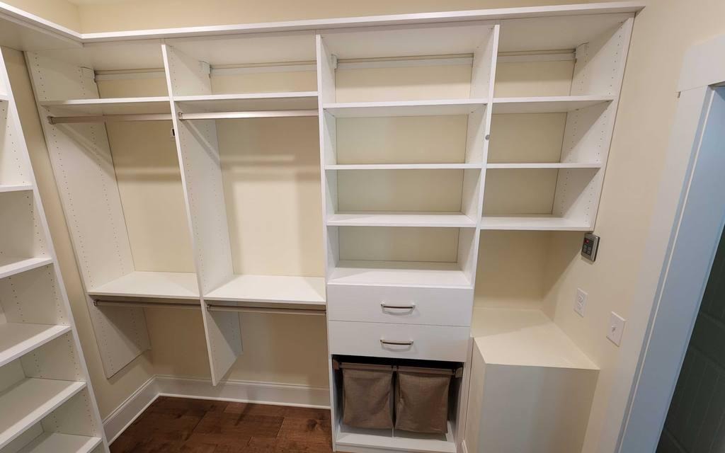 White Walk-In Closet Walk-In closet with built-in hampers