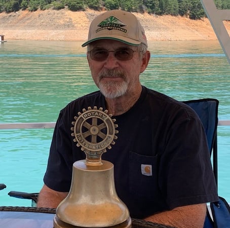 Man holding Anderson Rotarian statue