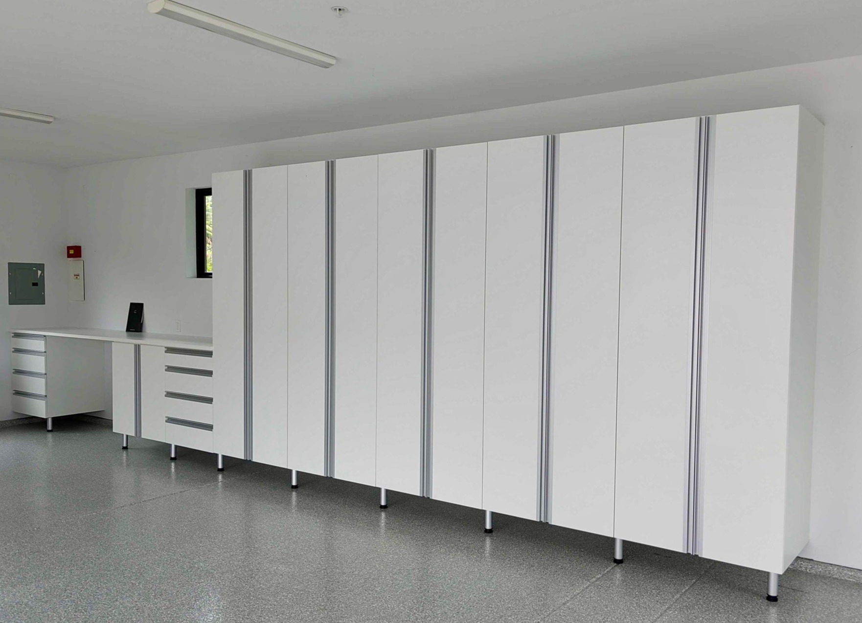 White Garage Storage with Modern Extruded Handles Custom designed and locally made garage storage by California Closets San Diego, California.