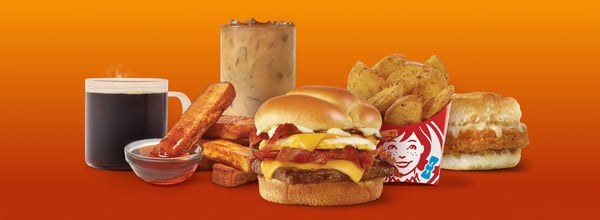 Wendy’s Baconator, Wendy’s Seasoned Potatoes, Wendy’s Homestyle French Toast Sticks, Wendy’s Premium coffee, Coca-Cola soft drink.