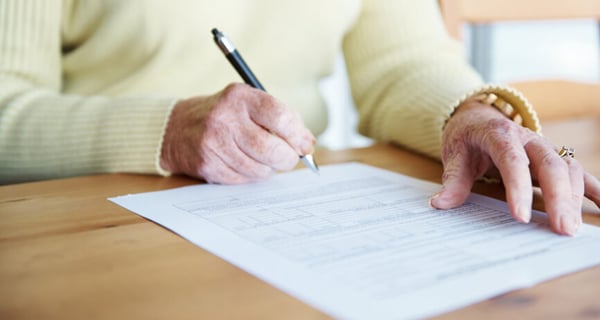 Close-up of women's hands while completing health documents