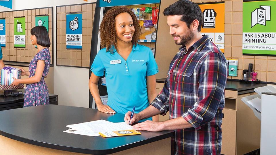 Friendly The UPS Store employee helping a customer