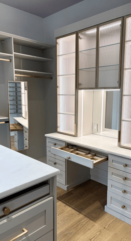 A custom primary walk-in closet with a dedicated vanity space, complete with illuminated mirror lighting for a refined, boutique-inspired experience.
Designed in Charlotte, NC. A custom primary walk-in closet with a dedicated vanity space, complete with illuminated mirror lighting for a refined, boutique-inspired experience.
Designed in Charlotte, NC.
