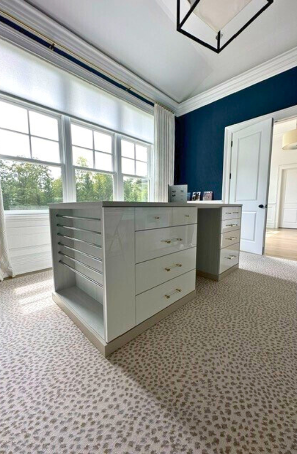 Custom Craft/Wrapping Room Craft room center island wrapping station with countertop and storage for wrapping paper on the side of the island.
