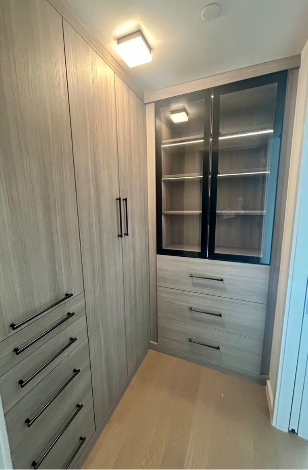 Gray & Black Walk-in Closet Img 8 - California Closets Nassau County Small Spaces Gray and Black walk-in closet with black hardware and glass doors closed cabinetry