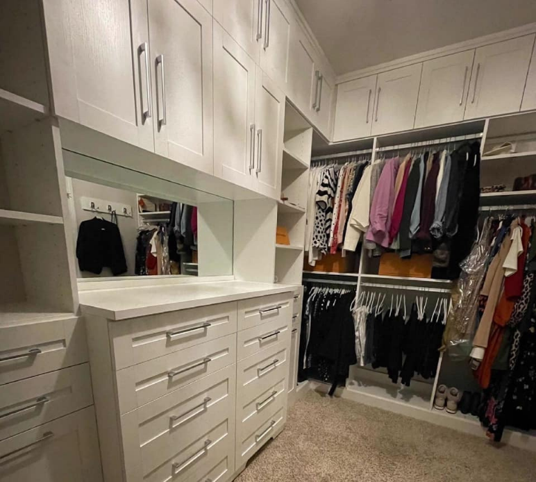 Custom Walk-In Closet Closet with hanging space, shelving, drawers, and cabinets.