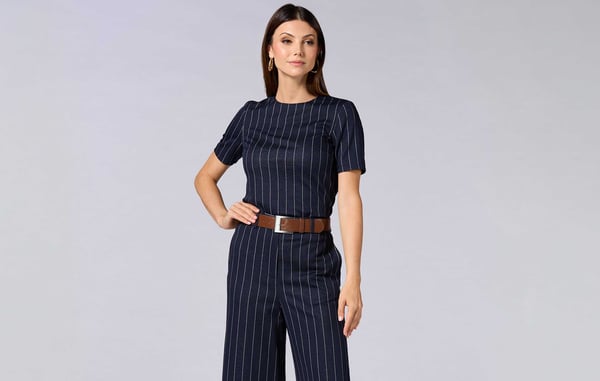Woman is wearing a blue pin stripe matching set from Cache.