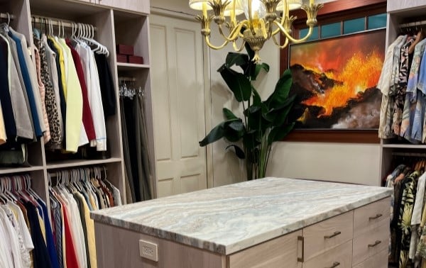 Step Into Luxury Large walk-in closet with double hang clothing storage and center island.