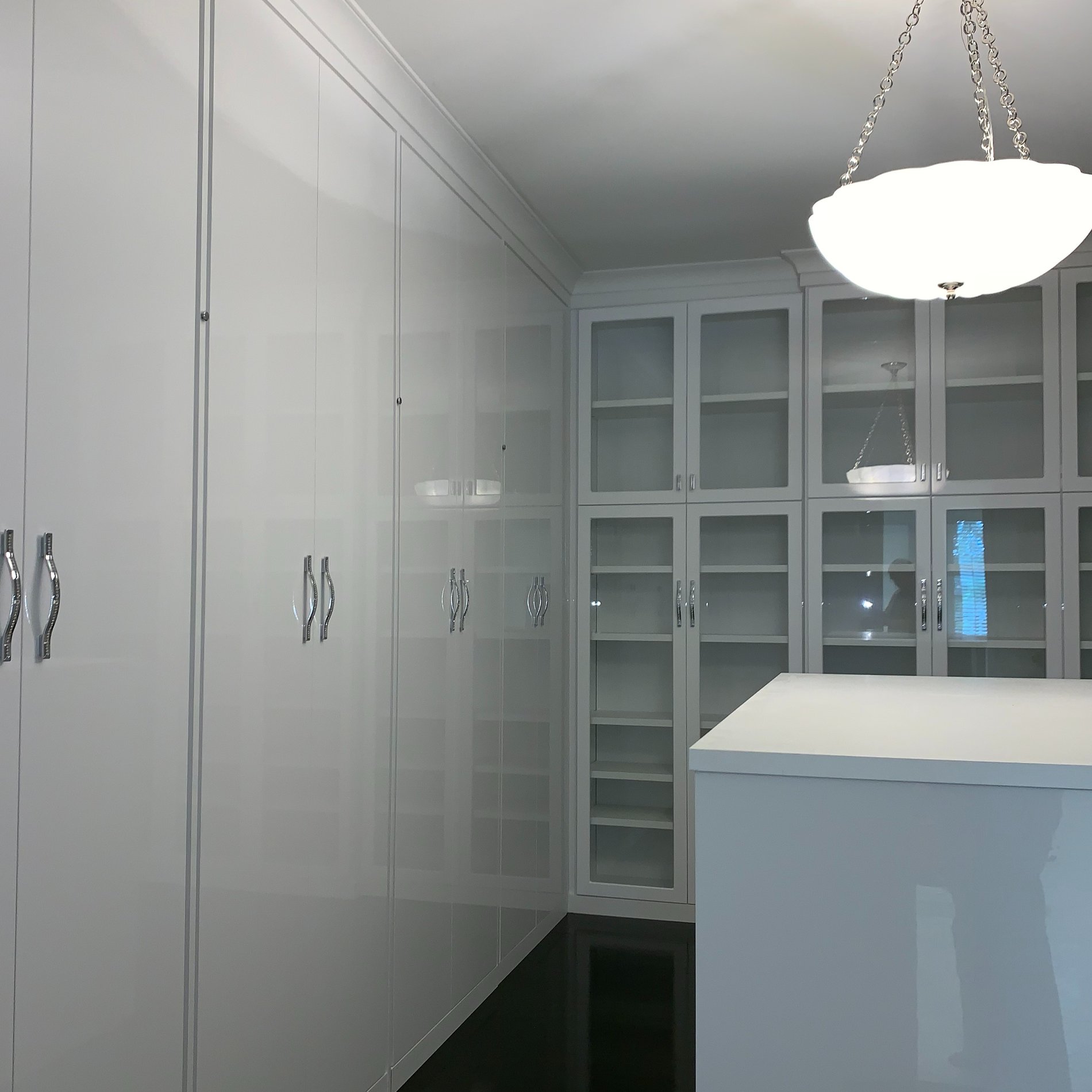 Elegant Luxe Dressing Room with Gloss White Glass Doors and Crystal Handles LUXE DRESSING ROOM with GLOSS WHITE GLASS DOORS, an ISLAND and CRYSTAL HANDLES