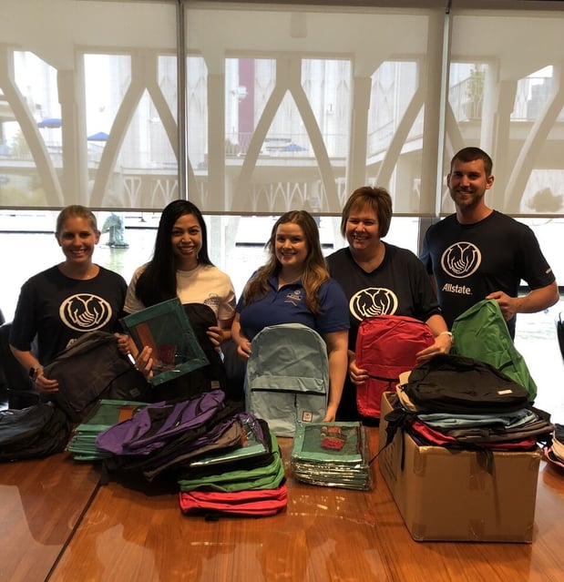 Stuffing backpacks for underserved youth in the community.