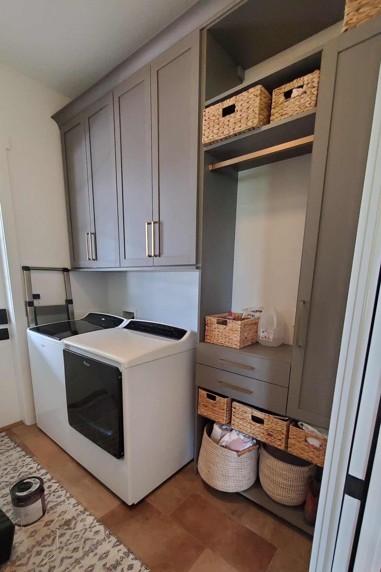Custom Cabinets for Laundry Room Cabinets for laundry room with laundry hamper with gold accents by California Closets Baldwin County & Mobile, Alabama.