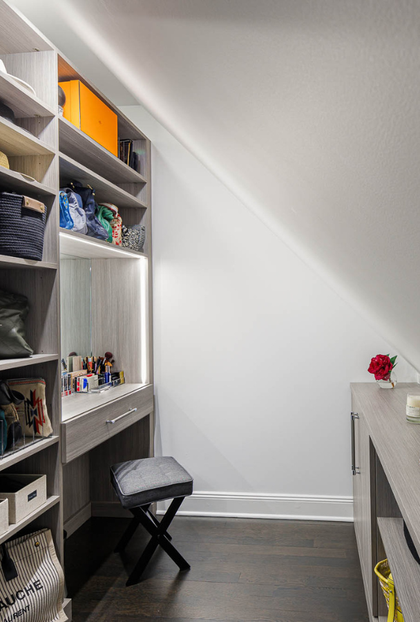Gray Small Nook Img 3 California Closets Armonk New York Gray Walk-in Closet with Angled sloped ceiling, Vanity with Built-in Lighting and Custom Shelving Storage