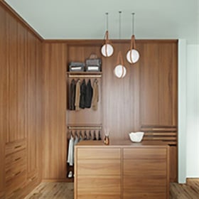 Feng Shui-inspired closet designs Custom designed walk in closet in natural wood grain finish with floor to ceiling storage created by California Closets