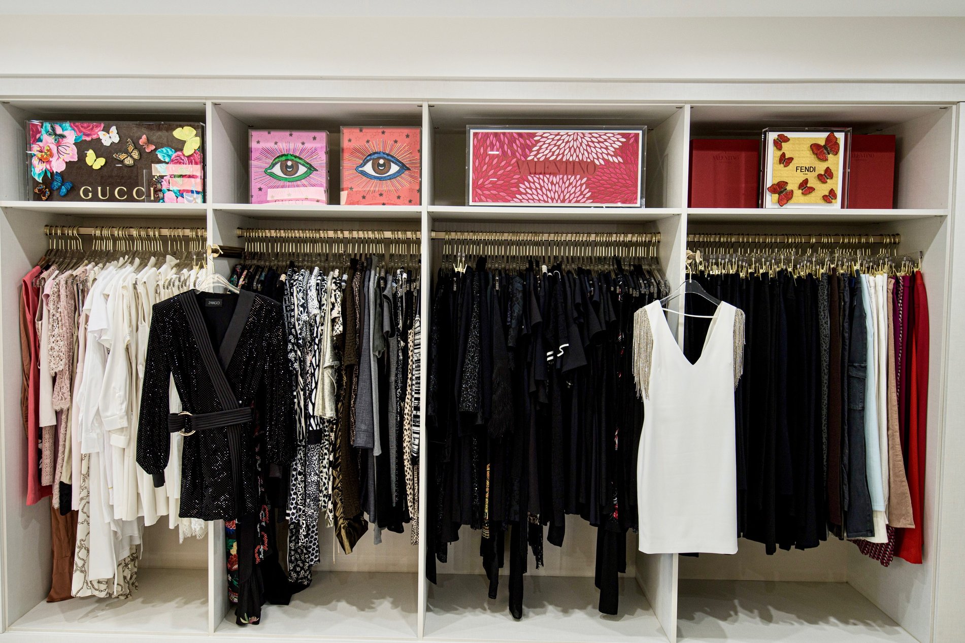 Classic Walk-In White closet organization with gold hanging poles California Closets New Orleans & Gulf Coast