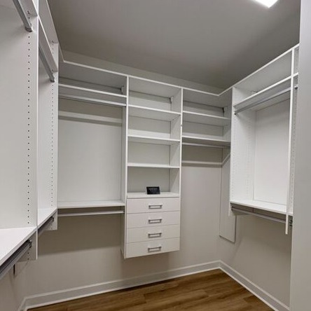 Reach-in nursery closet Greensboro - Custom closets - white walk-in closet with racks, shelves, and drawers