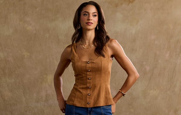 Woman is wearing layered gold jewelry