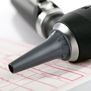 Image of otoscope and audiogram