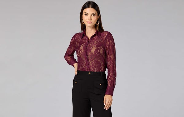 Woman is wearing a maroon lace button down top