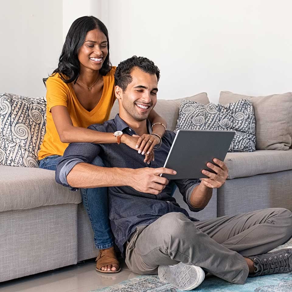 A couple applies online using their laptop