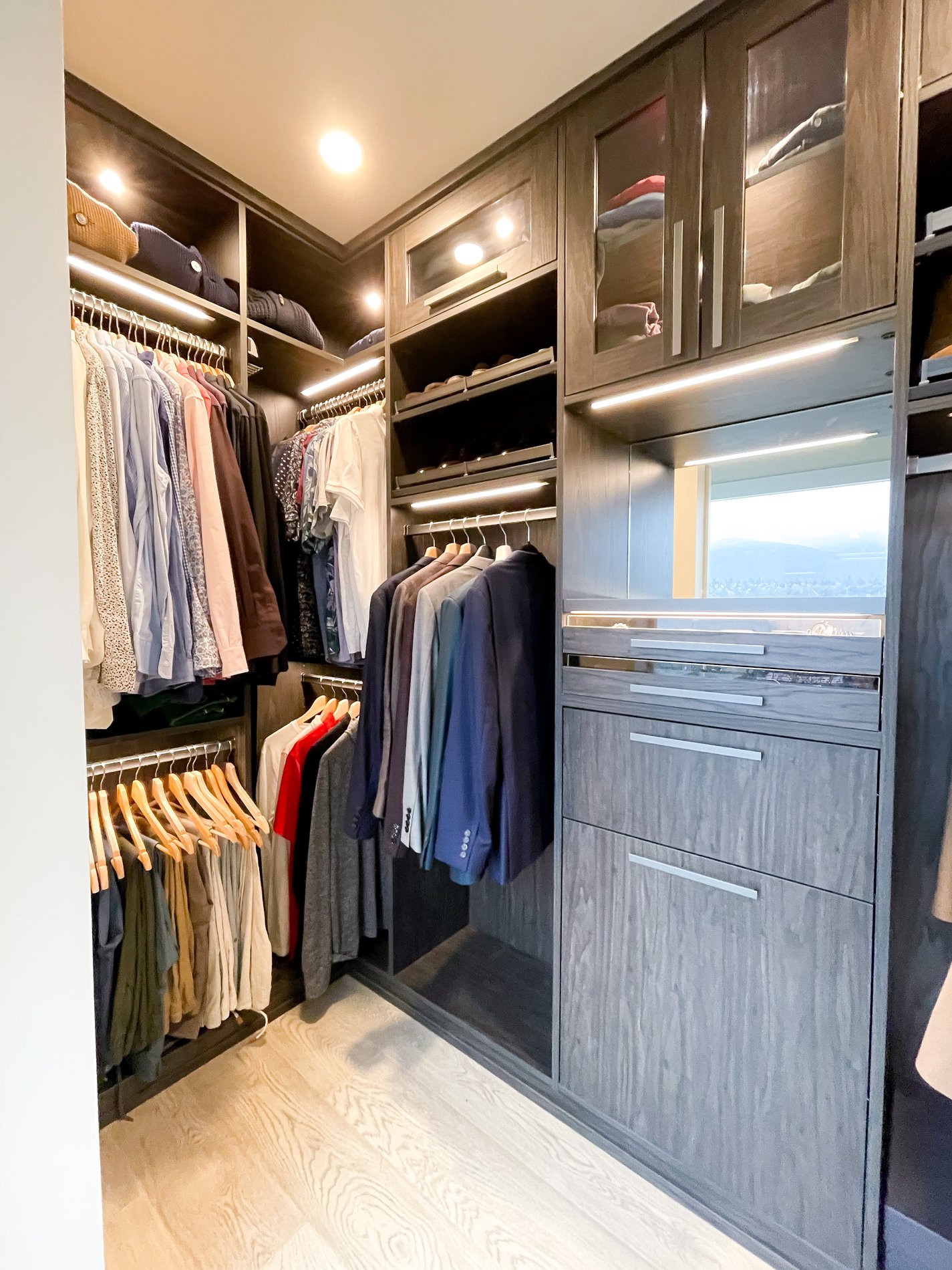 Walk-in closet Dark wood toned walk in closet with hanging and some shelving