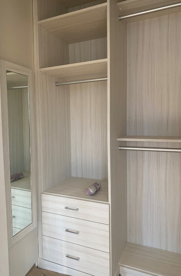 Light Gray Walk-in Closet California Closets Nassau County New York City closet shelf organizers small closet ideas small walk in closet ideas white walk in closets walk in closet designer custom closets