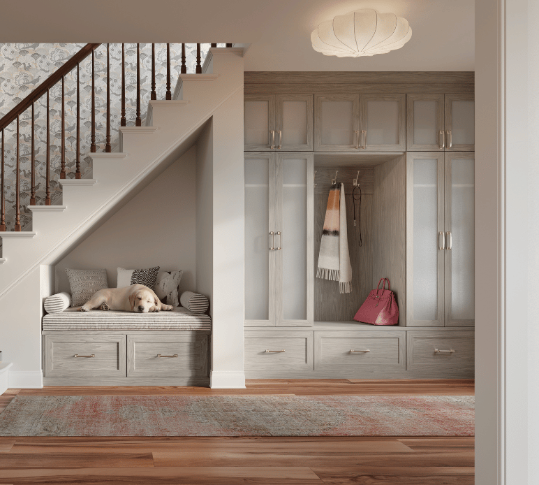 Custom Under the Stairs Entryway Custom Mudroom Entryway Built-In Storage Light Grey Wood Grain Cabinetry Glass Front Doors with Bench Seating and Storage, Drawer Storage Crown Molding Storage for Foyer by California Closets South Palm Beach Florida