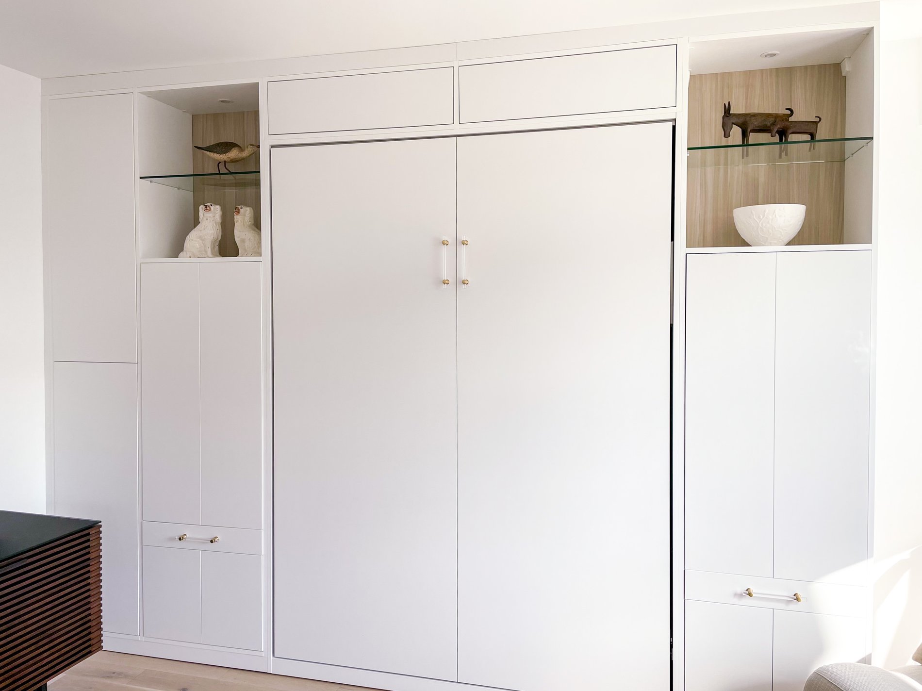 Modern wall bed and storage Modern, sleek wall bed that blends nicely with the white of the room