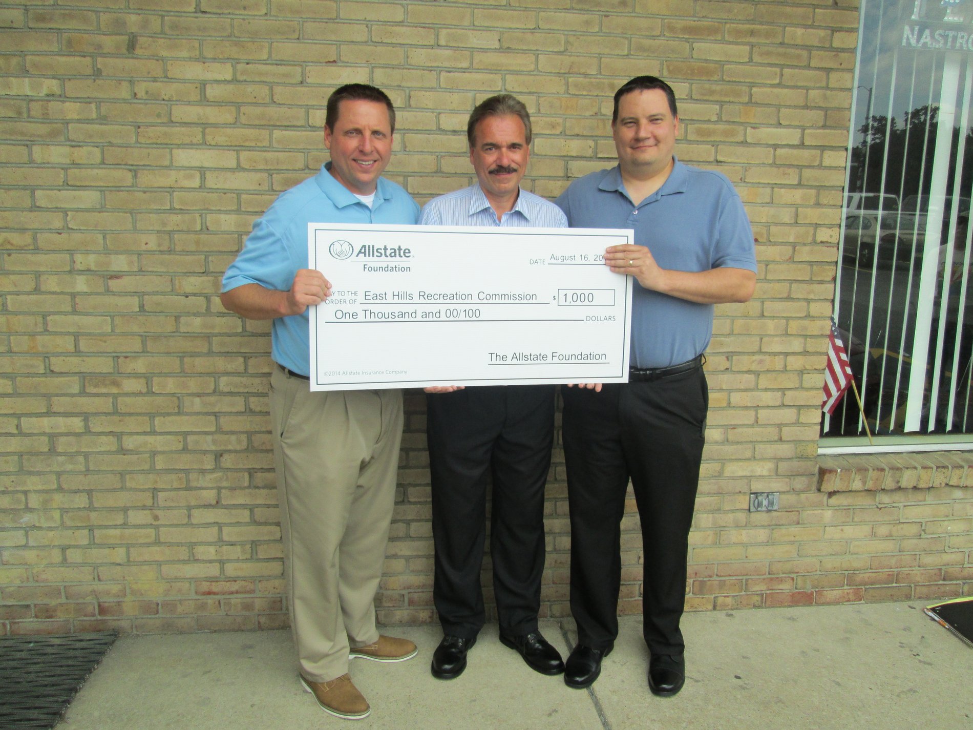 Duaine Detrick (Allstate agency owner) presents a $1,000 Allstate Foundation Hands in the Community Grant check as a volunteer to East Hills Recreation Commission.