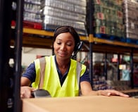 Woman worker at warehouse with barcode scanner