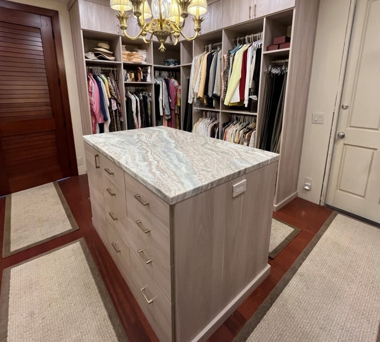 Expansive Walk-In Closet large walk-in closet with hanging space, upper cabinets and center island