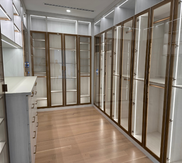 White Walk-in with Gold Trimmed Glass Doors California Closets Long Island City New York walk in closet design custom closets closet designers designer closets closet shoe storage built-in closets closet systems closet drawer organization closet shelf